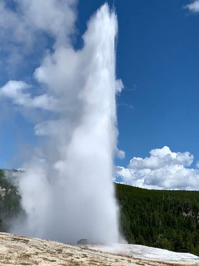 Old Faithful geyser erupting in Yellowstone