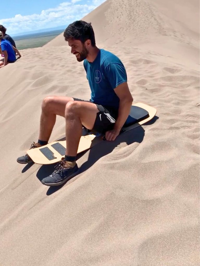 Sledding down dunes in Colorado