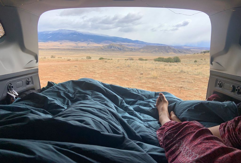 Car camping in the cold in a cozy bed setup